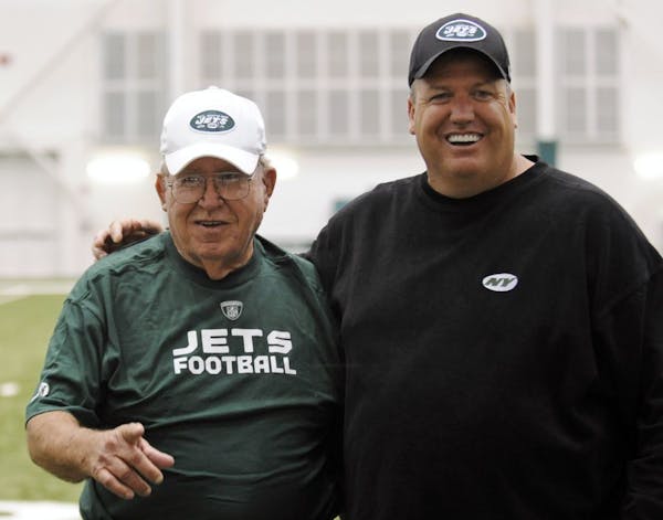 FILE - In tis June 6, 2009, file photo, New York Jets head coach Rex Ryan, right, poses for photographers with his father, Buddy, at the NFL football 