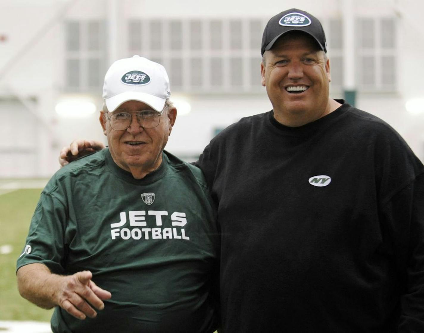 FILE - In tis June 6, 2009, file photo, New York Jets head coach Rex Ryan, right, poses for photographers with his father, Buddy, at the NFL football minicamp in Florham Park, N.J.