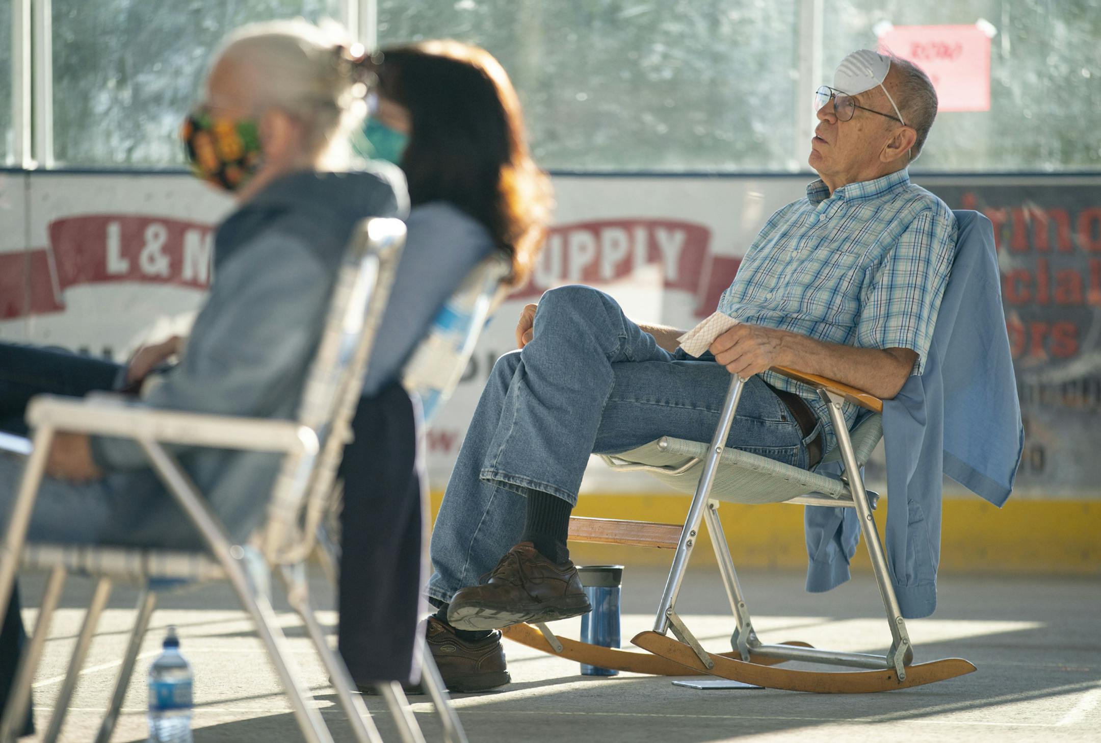 Jack Pick placed his face mask on his forehead while listening to Mollie B & Squeezebox perform on Thursday. ] ALEX KORMANN • alex.kormann@startribune.com Mollie B & Squeezebox performed in front of a crowd of around 120 people at the Reif Center in Grand Rapids, MN on Thursday July 16, 2020. It was the band's first public performance since before the COVID-19 pandemic on February 16. "Polka Pods" were chalked on the floor of the covered outdoor pavilion to ensure social distancing guidelines we