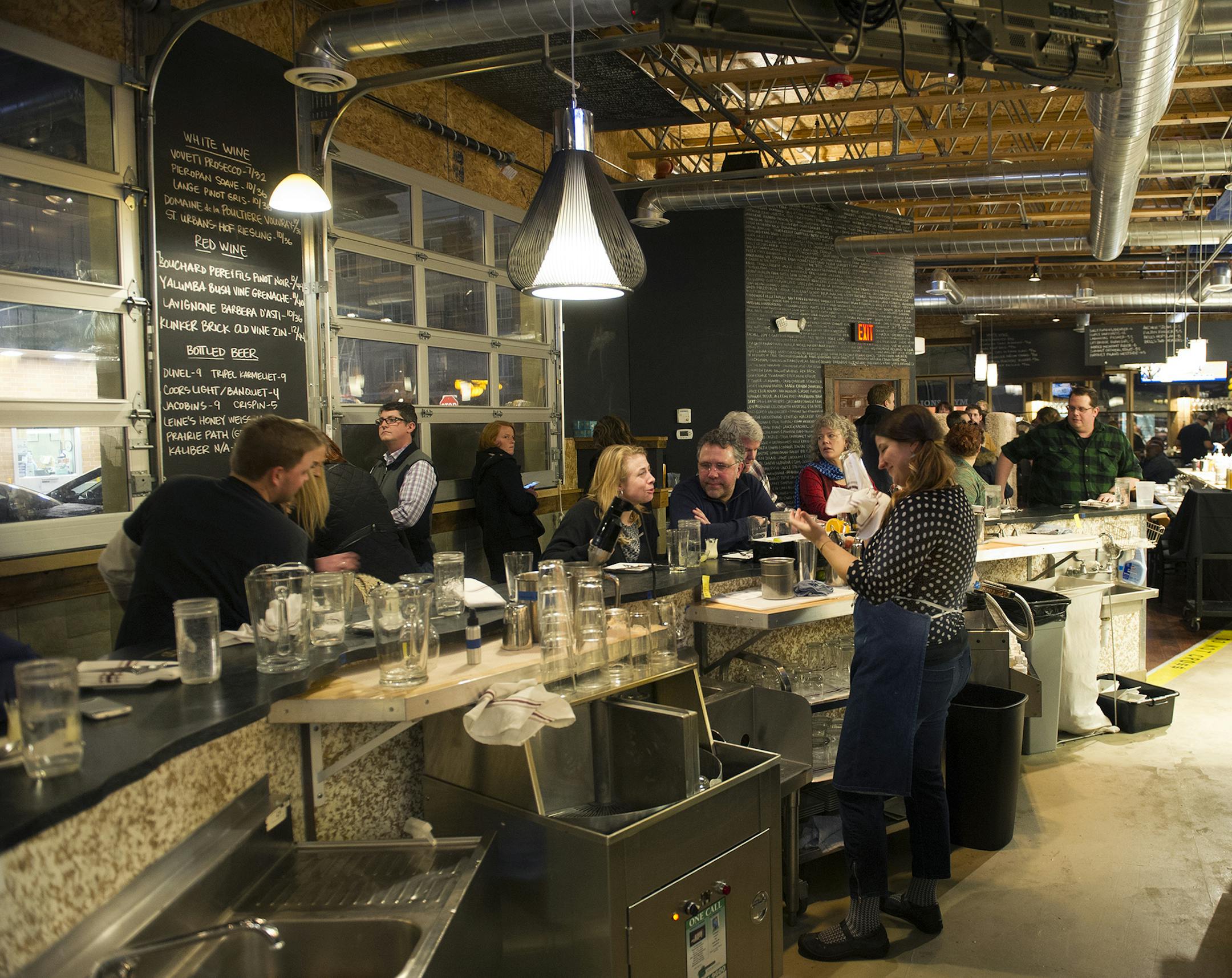 The bar at the Rookery is abuzz with guests, eager to try one of their signature cocktails, Friday, January 31, 2014. (Matthew Hintz, 020714, Robbinsdale)