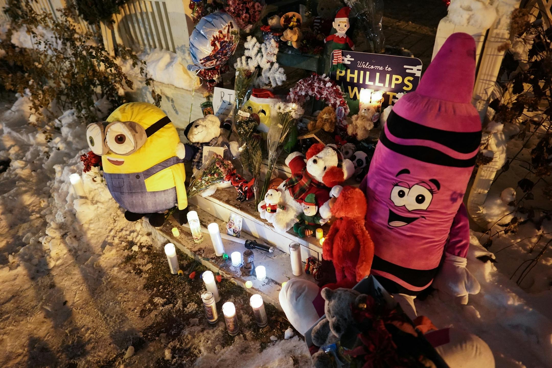 Mourners visit a vigil for slain Schladetzky family members at their home on Oakland Ave. South.