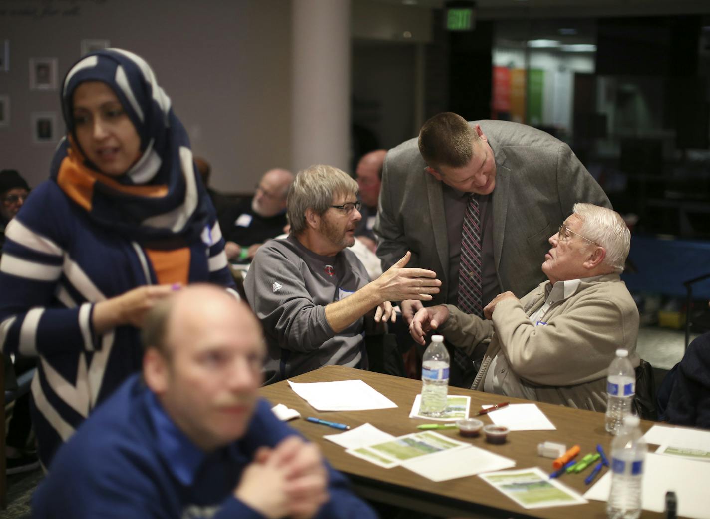 Brooklyn Park Mayor Jeff Lunde, standing, checked in with Keith Peterson and Eldon Tessman, right, while he observed their discussion group as it tackled how to make life in his city better during the interfaith community discussion Thursday night. Their small group was being led by Zillehuma Hudda, at left. ] JEFF WHEELER &#xef; jeff.wheeler@startribune.com Jeff Lunde, Brooklyn Park's mayor convened a city meeting of faith leaders and residents to express solidarity with the city's Muslim commu