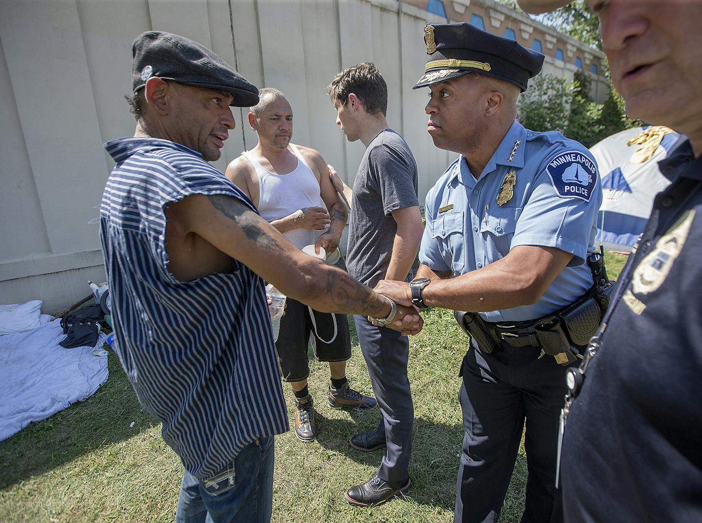 Minneapolis Mayor Jacob Frey, left, Police Chief Medaria Arradondo, center, and Sgt. Grant Snyder, right, visited a homeless encampment near Hiawatha Avenue in Minneapolis.