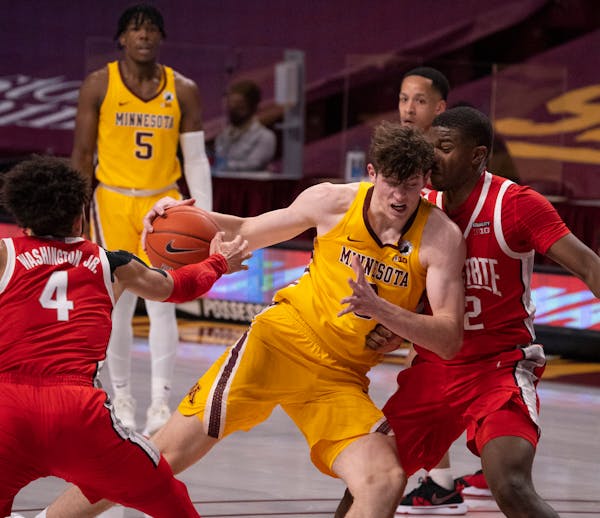 Gophers center Liam Robbins drove hard against the defense of Ohio State forward E.J. Liddell in the first half,