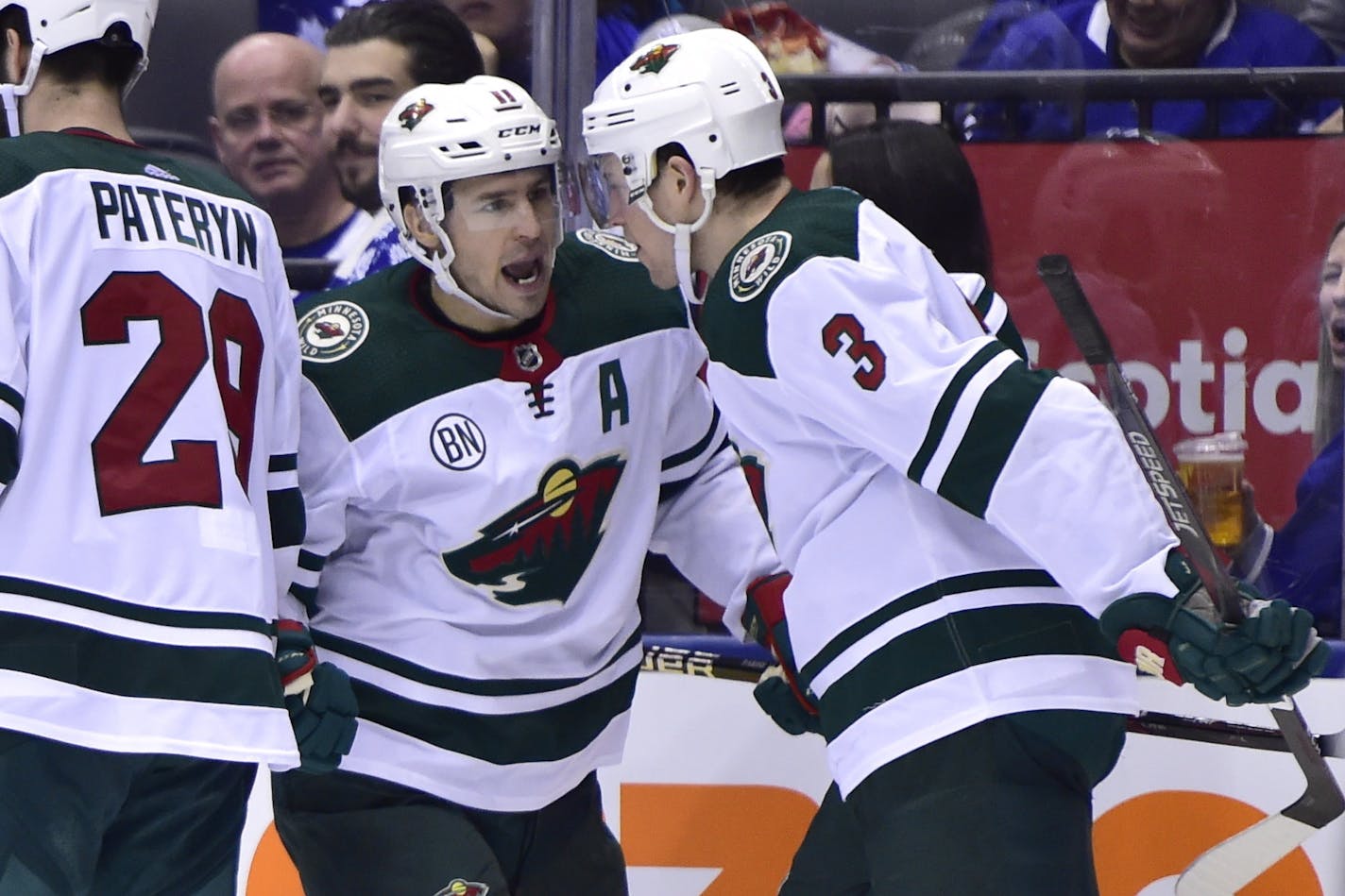 Minnesota Wild left wing Zach Parise, center, celebrates his goal against the Toronto Maple Leafs with teammates Charlie Coyle (3) and Greg Pateryn (29) during the third period of an NHL hockey game, Thursday, Jan. 3, 2019 in Toronto. (Frank Gunn/The Canadian Press via AP)