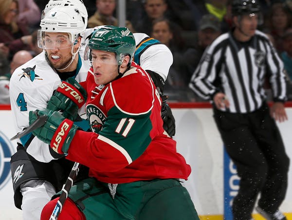 The Wild's Zach Parise, right, battled San Jose's Brenden Dillon on April 5, the day he aggravated his back injury.