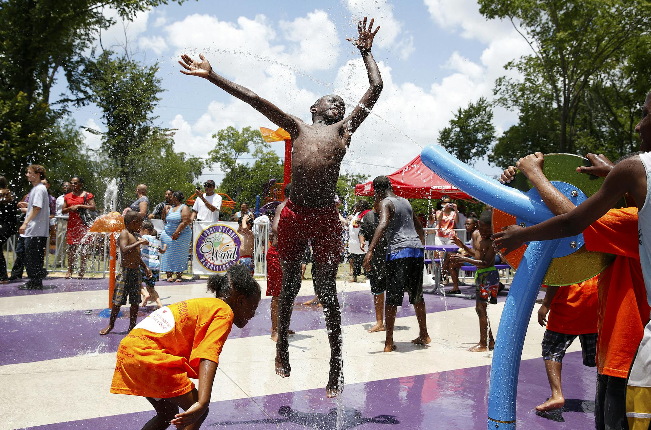 IMAGE DISTRIBUTED FOR RELIANT - Kids enjoying the Reliant donated Solar-Powered Splash Pad during the grand opening event in Houston's 5th Ward on Monday, June 17, 2013 in Houston, Texas. (Aaron M. Sprecher/AP Images for Reliant) ORG XMIT: MIN2013061916371829
