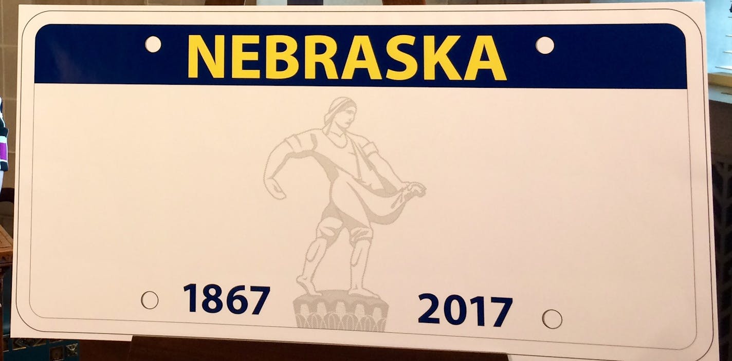 Nebraska Department of Motor Vehicles Director Rhonda Lahm poses next to a design for the the state&#x2019;s new standard license plate at a news conference, Tuesday, March 22, 2016 at the Capitol in Lincoln, Neb. State law requires the DMV to issue a new design every six years. The department expects to create about 5.2 million of the new plates between 2017 and 2022. (AP Photo/Anna Gronewold)