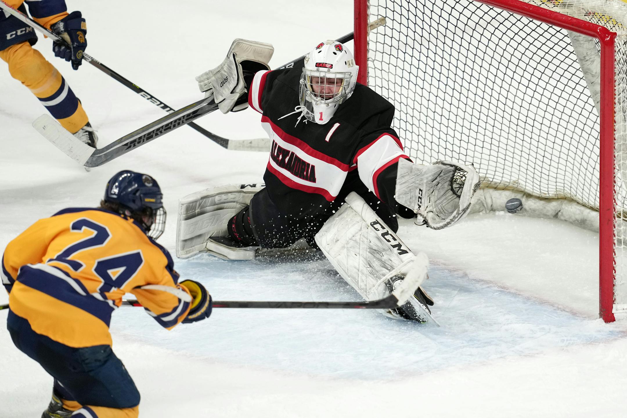 Mahtomedi forward Corey Bohmert (24) scores on Alexandria goaltender Elijah Rasmusen (1) in the second period of a MSHSL Class 1A quarterfinal hockey game between Alexandria and Mahtomedi.