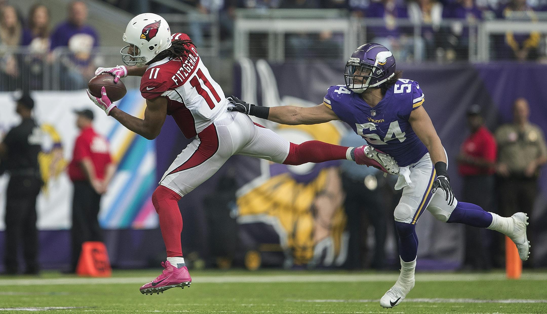 Arizona Cardinals wide receiver Larry Fitzgerald (11) picked up a first down over Minnesota Vikings linebacker Eric Kendricks (54) in the forth quarter at U.S. Bank Stadium Sunday October 14, 2018 in Minneapolis, MN.
