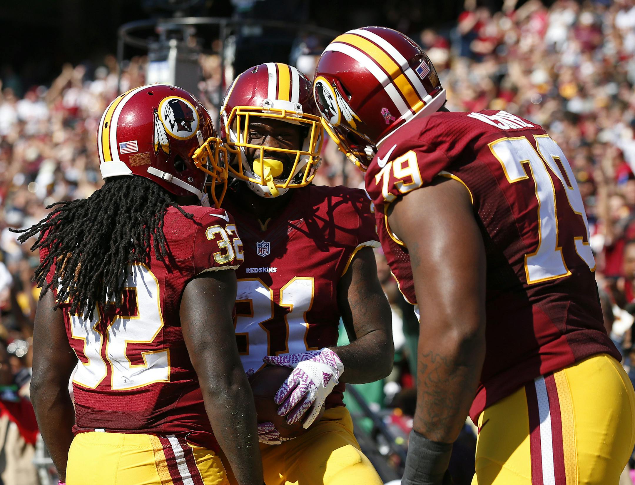 Washington Redskins running back Matt Jones, center, celebrates his touchdown with teammates Rob Kelley, left, and Ty Nsekhe in the first half of an NFL football game against the Philadelphia Eagles, Sunday, Oct. 16, 2016, in Landover, Md. (AP Photo/Alex Brandon)