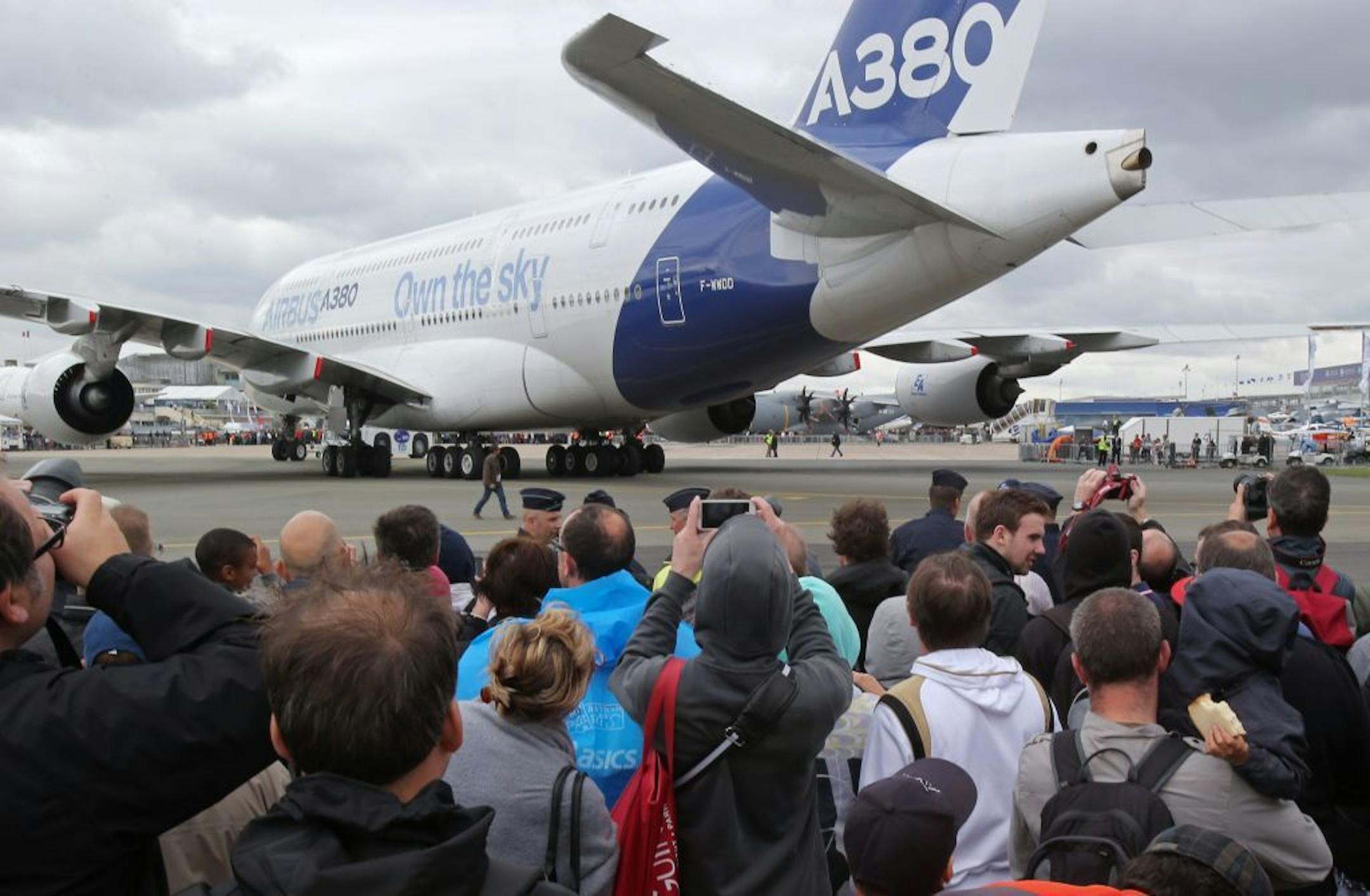 Visitors look on a Airbus A380 jet liner during the 50th Paris Air Show at Le Bourget, north of Paris, Saturday, June 22, 2013.