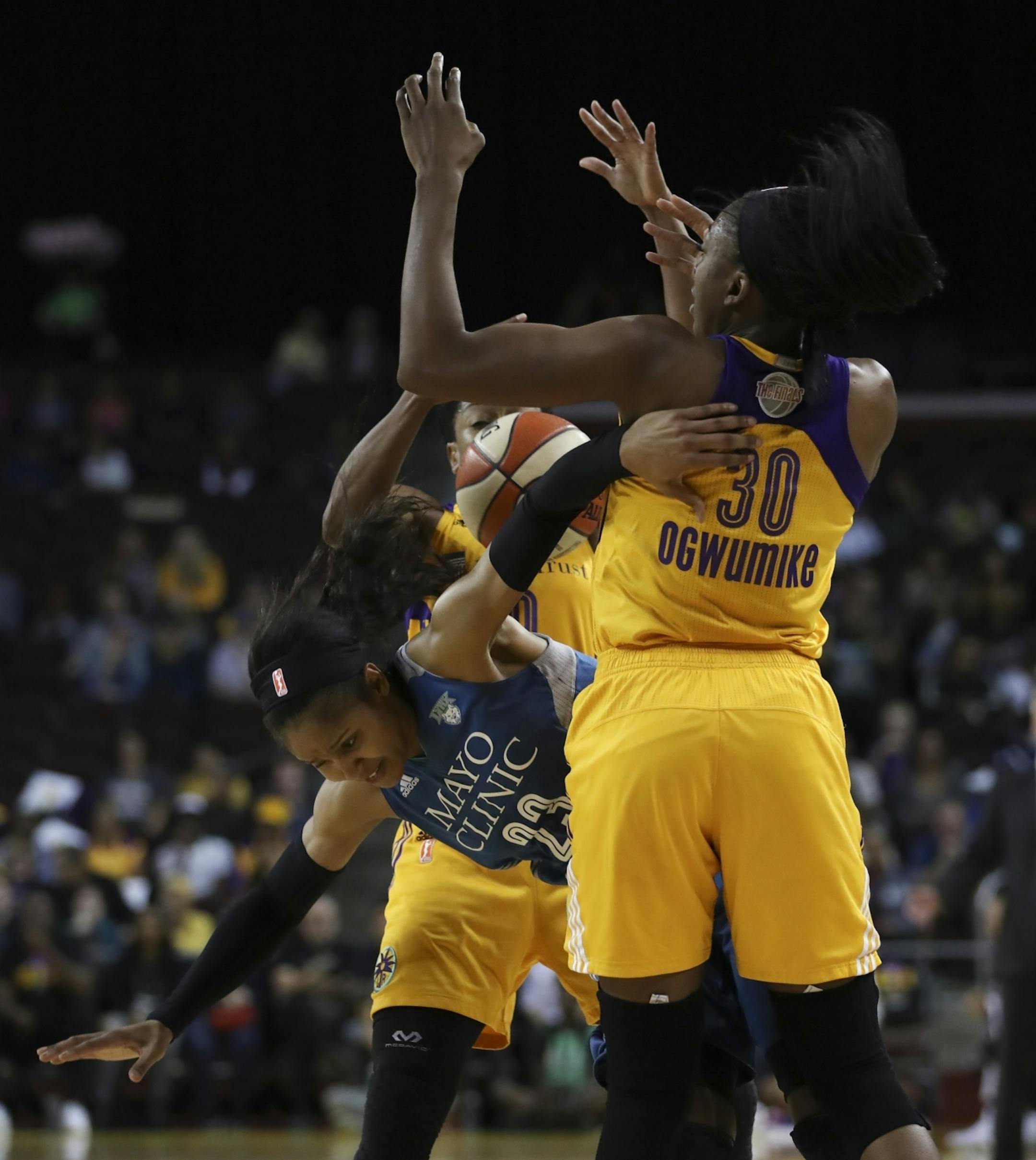 Minnesota Lynx forward Maya Moore (23) was stripped of the ball as she was defended hard by Los Angeles Sparks guard Alana Beard (0) and forward Nneka Ogwumike (30) in the second quarter.
