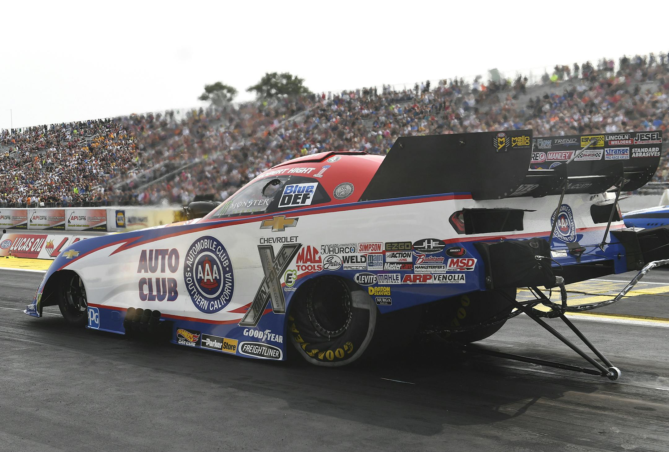 In this photo provided by the NHRA, Robert Hight drives in Funny Car qualifying at the Lucas Oil NHRA Nationals drag races at Brainerd International Raceway on Saturday, Aug. 18, 2018, in Brainerd, Minn. Hight drove to a 3.959-second pass at 324.67 mph to earn the No. 1 qualifying position. (Marc Gewertz/NHRA via AP)
