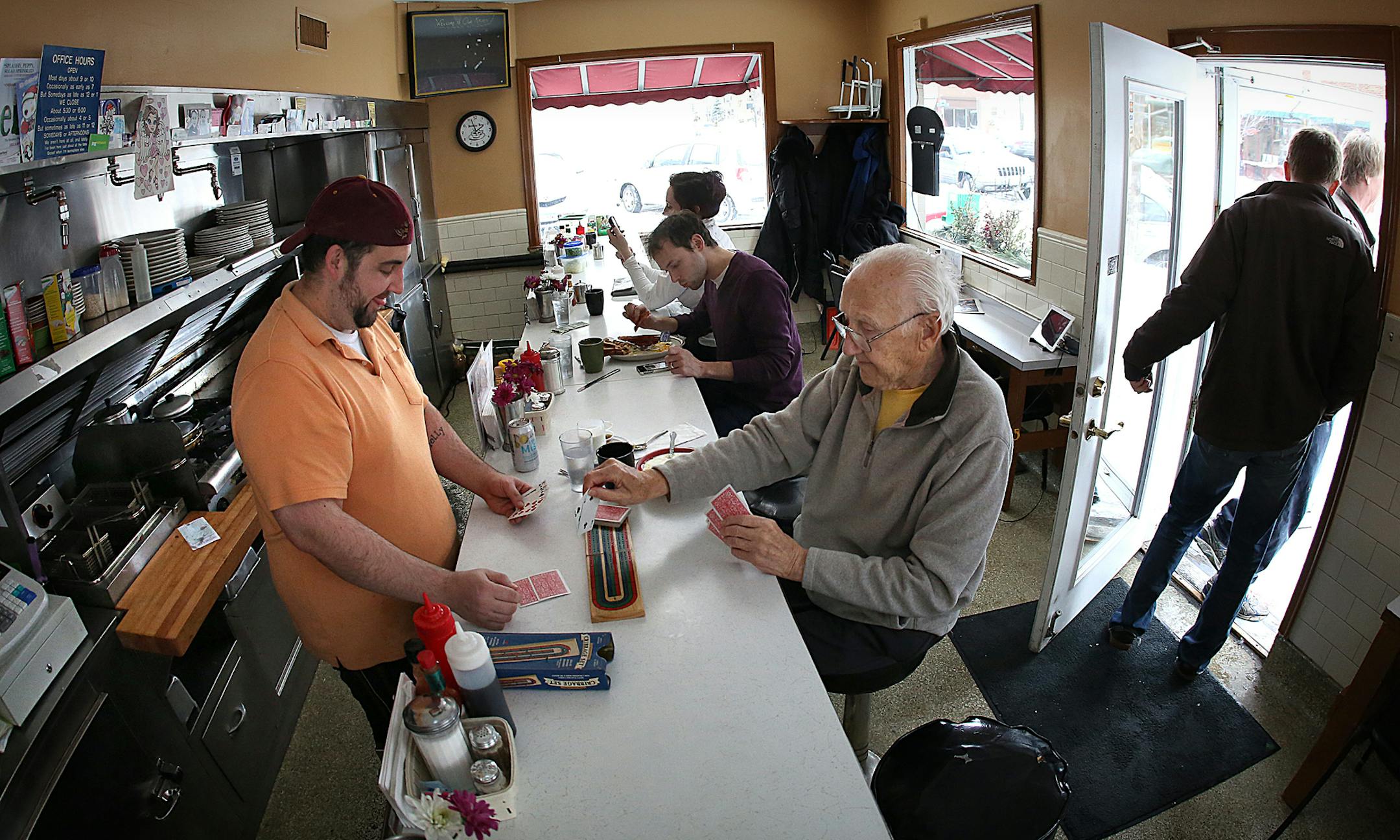 Every Monday afternoon, Joey Ziegler, 33 (left) and Peter Muscala, 92, sit at the counter of Our Kitchen caf&#xe9; in South Minneapolis and play a lively game of cribbage. Joey, a cook, sometimes turns away to flip a burger, while Pete continues to concentrate on the game or take a bit of his lunch. ] Photo by Jim Gehrz / JIM GEHRZ&#x2022;jgehrz@startribune.com (JIM GEHRZ/STAR TRIBUNE) / February 11, 2013 / 1:30 PM Minneapolis, MN