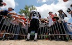 Adrian Peterson signed autographs for fans during a workout in New Orleans.