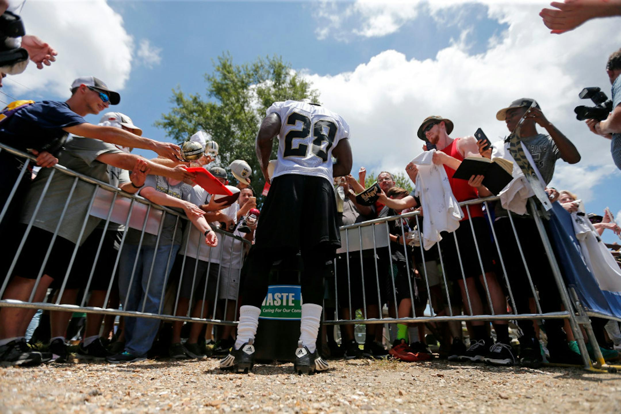 Adrian Peterson signed autographs for fans during a workout in New Orleans.