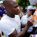 Minnesota Vikings running back Adrian Peterson signs a Wheaties box with his picture on it as he reports to an NFL football training camp at Minnesota