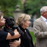 Gus Walz held Scout, a 3-month-old Labrador Retriever the Walz family adopted, during a press conference to announce the family's newest addition at the residence Thursday afternoon.