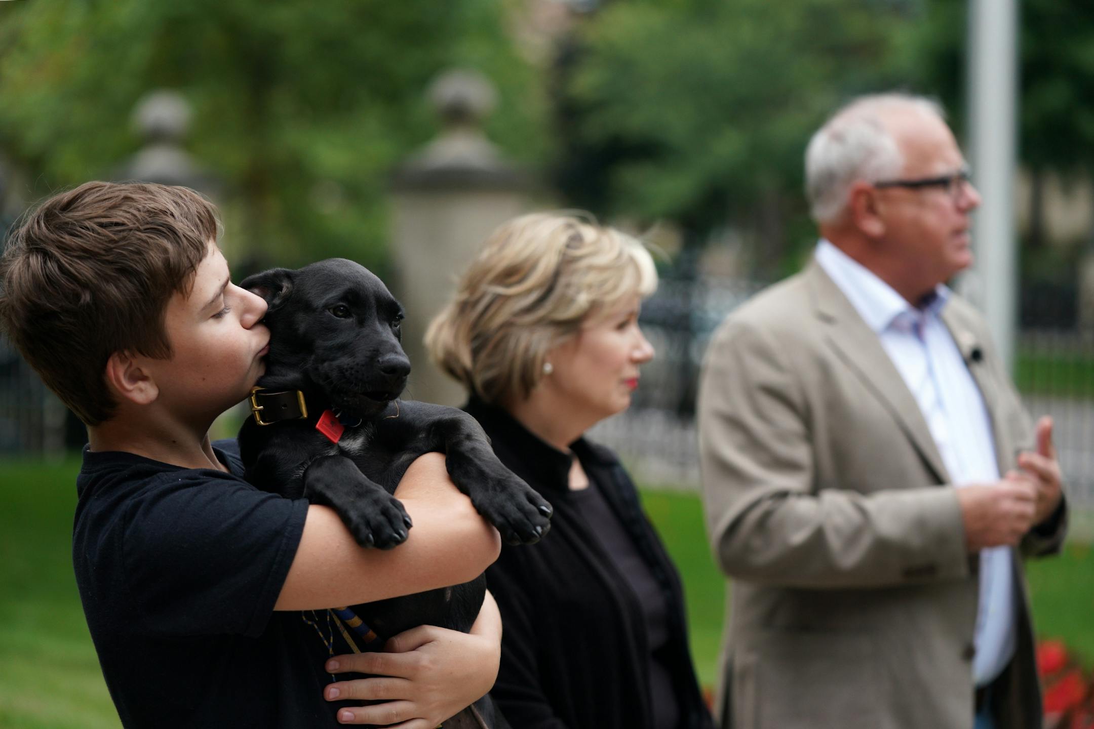 Gus Walz held Scout, a 3-month-old Labrador Retriever the Walz family adopted, during a press conference to announce the family's newest addition at the residence Thursday afternoon.