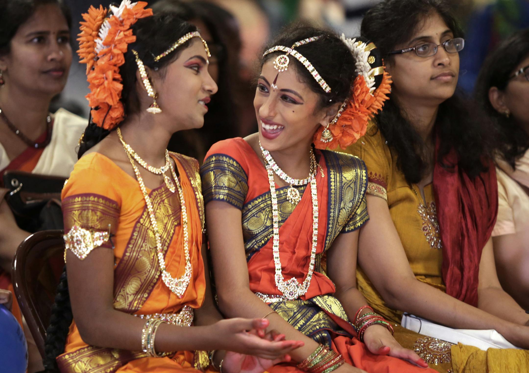 Sriya Yemireddy, 11, left, and sister Samni Penmatsa, 11, enjoyed a moment watching other dancers before their own dance performance. Sunday was "Cultural Heritage Day" at the Hindu Temple of Minnesota in Maple Grove. Activities included dance and musical performances, henna decorations, Rongoli (sacred ancient symbols to welcome Hindu deities), plenty of food and student projects. Folks could also visit the temple. On Oct.18, the Hindu community will celebrate Diwali, the festival of lights, at