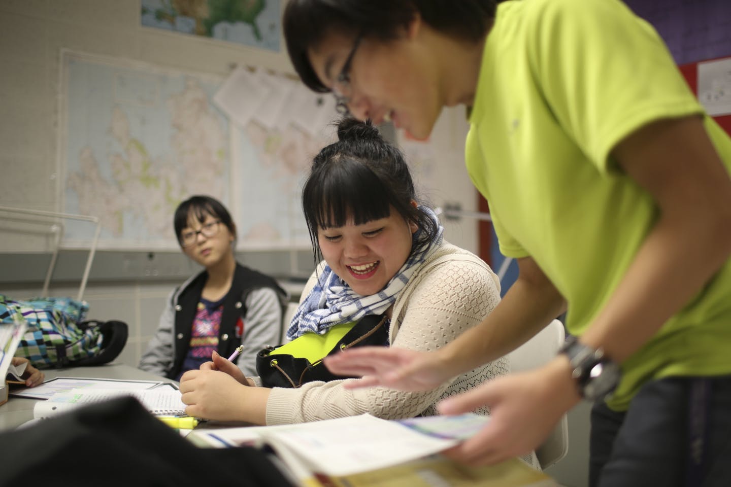 T.C. Vang filled in Michelle Vang on their health homework as they studied with other Upward Bound program students after school Wednesday at Brooklyn Center High School.