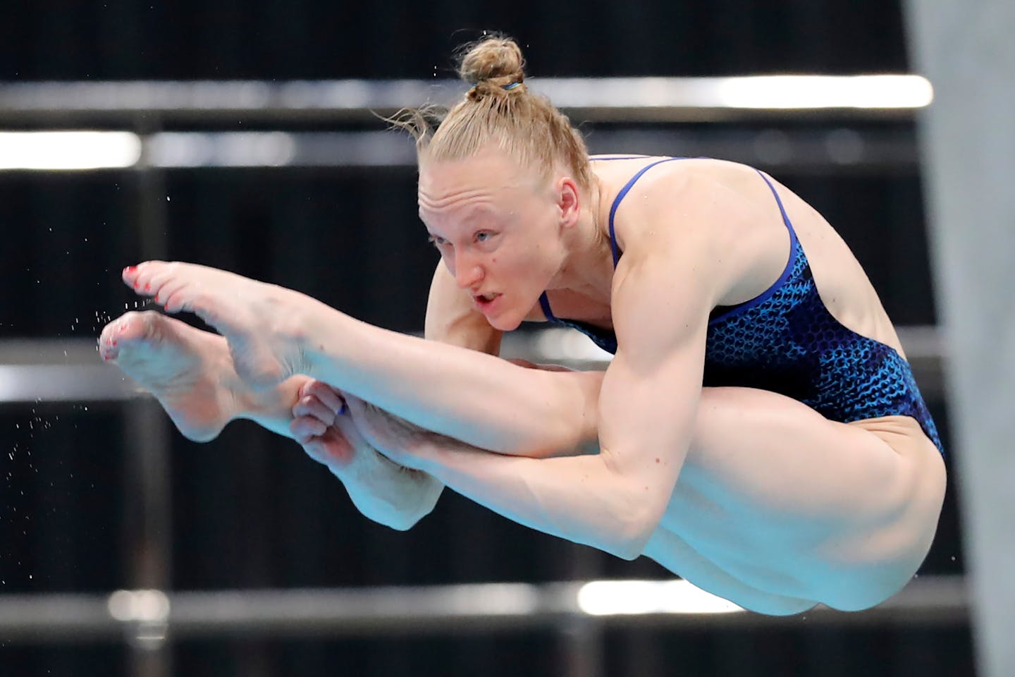 Bacon Sarah performs a dive during the women's 3-meter springboard final at the FINA Diving World Cup in Tokyo on Tuesday