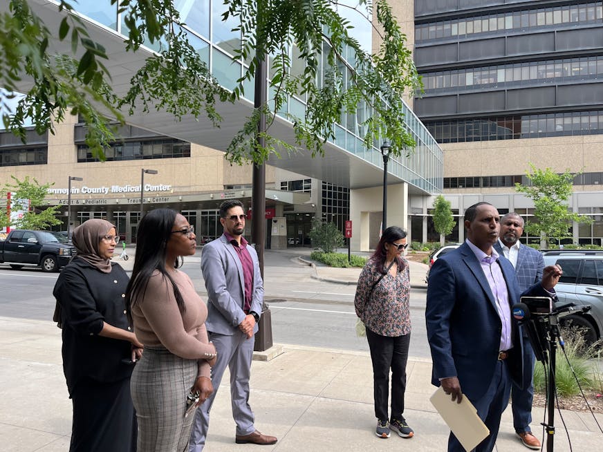 Hennepin Healthcare System's Board Chair Mohamed Omar stands with members of the board outside HCMC. The board might be dissolved if a Hennepin County Board resolution passes to give the commissioners a more active role over the hospital.