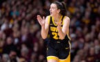 Caitlin Clark of the Iowa Hawkeyes cheers on a teammate during a game against the University of Minnesota on Wednesday at Williams in Minneapolis.
