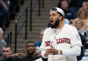Karl-Anthony Towns cheers for the Timberwolves while sidelined after arthroscopic knee surgery.