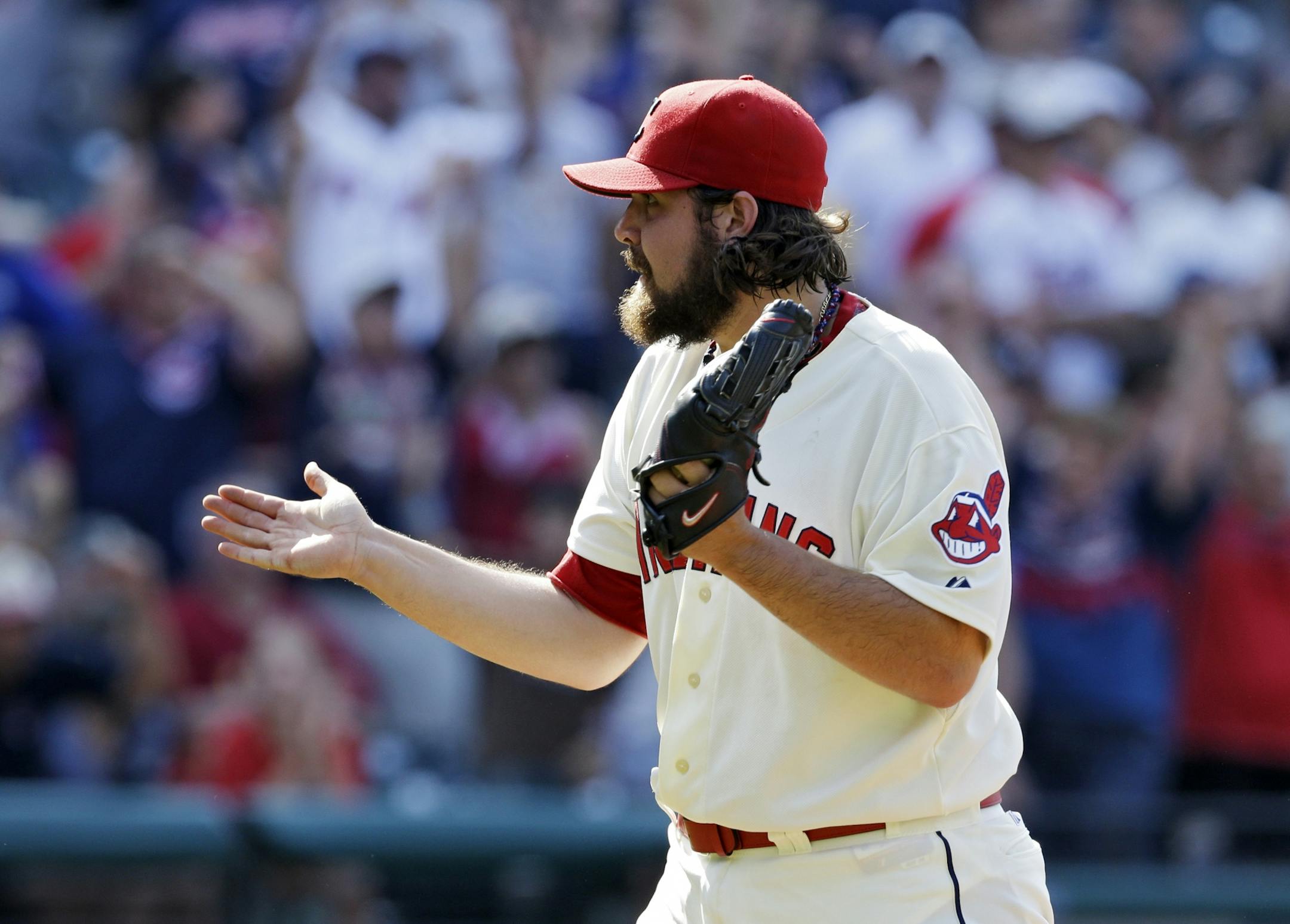 Cleveland Indians relief pitcher Chris Perez celebrates after striking out Minnesota Twins' Trevor Plouffe for the final out in a 3-1 win in a baseball game Sunday, Aug. 25, 2013, in Cleveland.