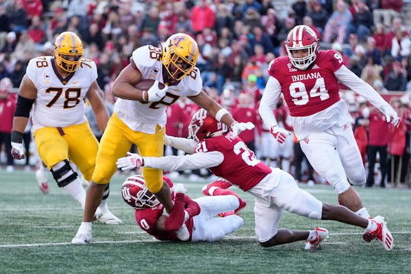 Minnesota tight end Brevyn Spann-Ford (88) is tackled by Indiana defenders Raheem Layne II (0) and Noah Pierre (21) in the first half during an NCAA c