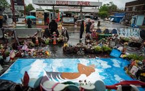Individuals arrive to pay their respects on the anniversary of George Floyd's death at GF Square in Minneapolis, Minn., on Wednesday, May 25, 2022. To