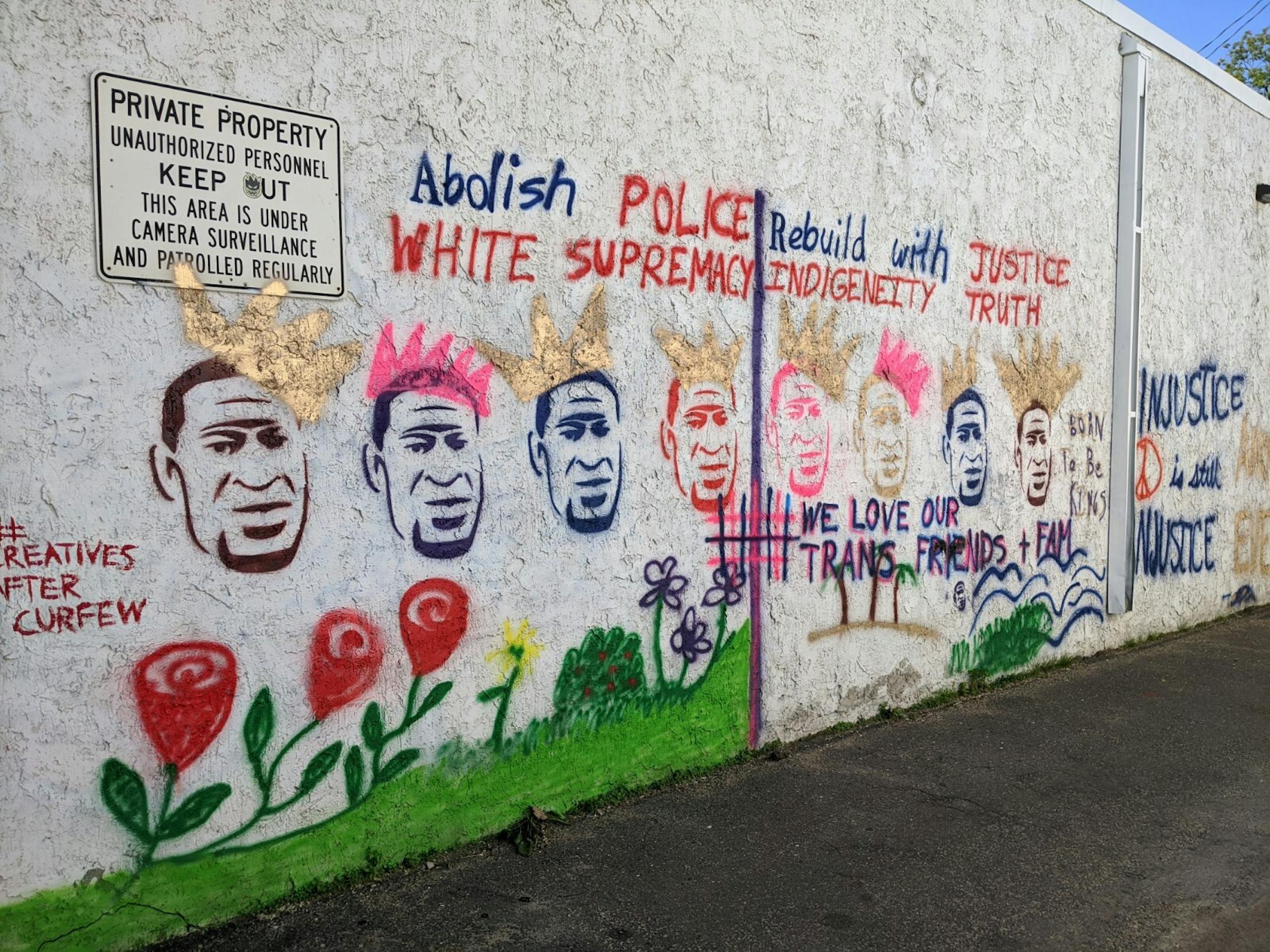 The artist collective loosely known as #creativesaftercurfew calls for a new future on their mural painted on Black-owned business Disaster Services Inc. at 3010 E Lake St.