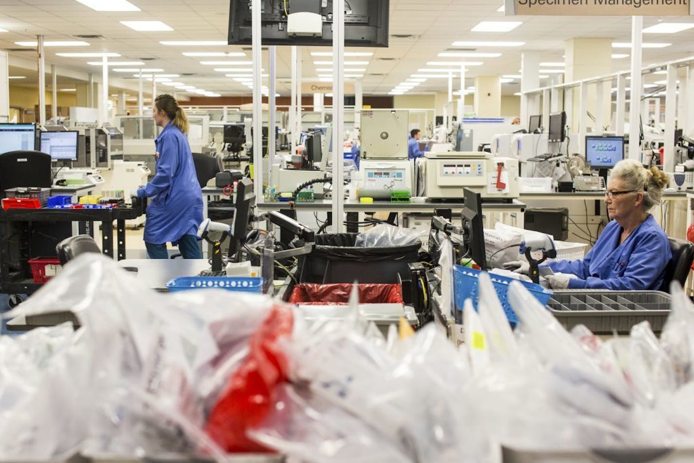 Clinicians work at Allina Health's full service clinical testing lab in Minneapolis on Dec. 20, 2016. Allina Health is restricting visitors at its 12 Twin Cities hospitals and its eye institute to protect patients and staff from influenza.