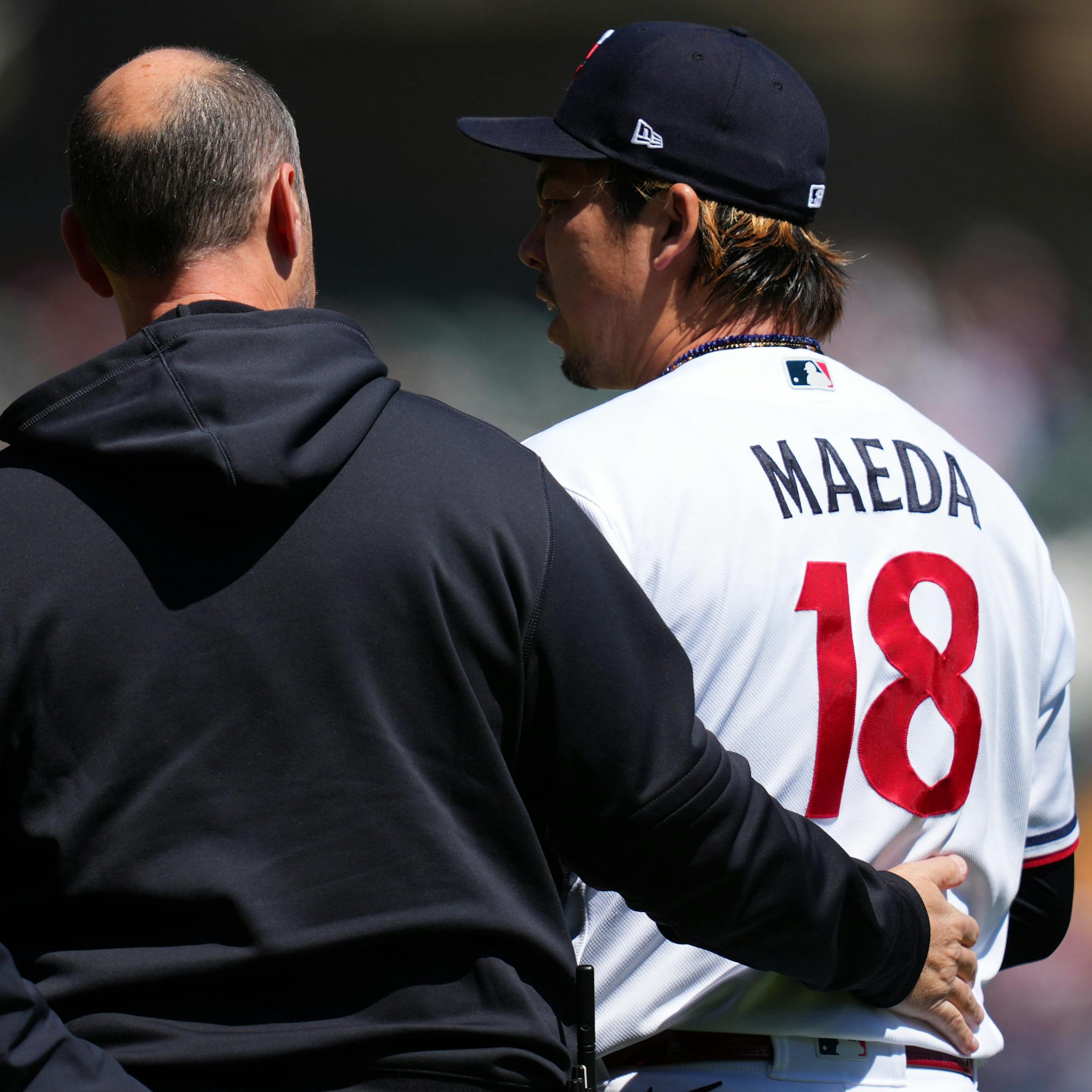 Minnesota Twins starting pitcher Kenta Maeda (18) is visited by trainers after trying to field a single hit by New York Yankees center fielder Isiah Kiner-Falefa (12) in the second inning.
