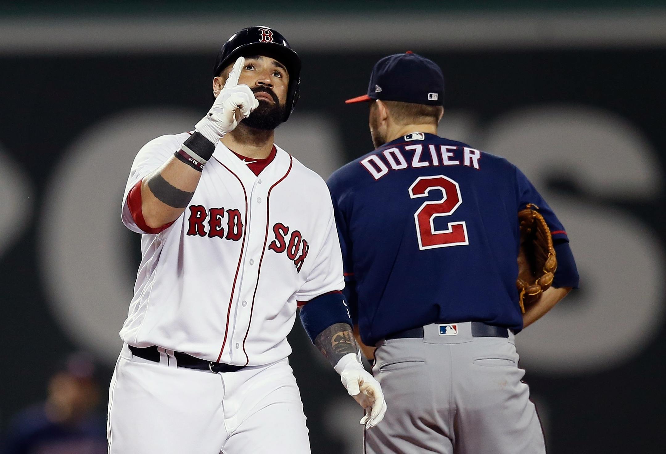 Boston Red Sox's Sandy Leon reacts beside the Twins' Brian Dozier after hitting a double during the sixth inning.