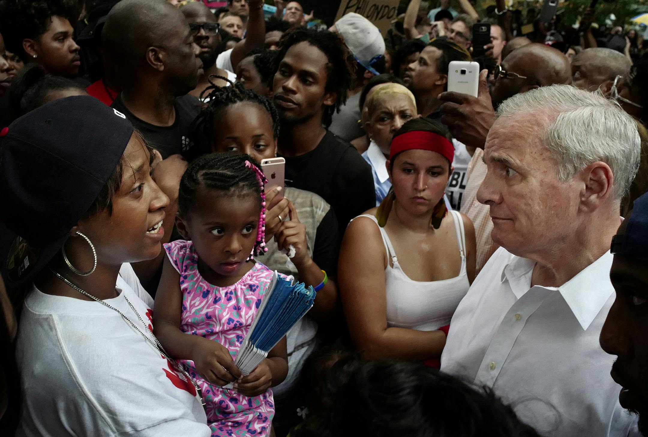 Minnesota Gov. Mark Dayton, right, meets with people, including Diamond Reynolds, left, and her daughter, at the Governor's Mansion as protesters gathered to decry the shooting death of Reynolds' boyfriend, Philando Castile, by police in Falcon Heights, Minn. (Richard Tsong/Star Tribune via AP) ORG XMIT: MIN2016070814483647