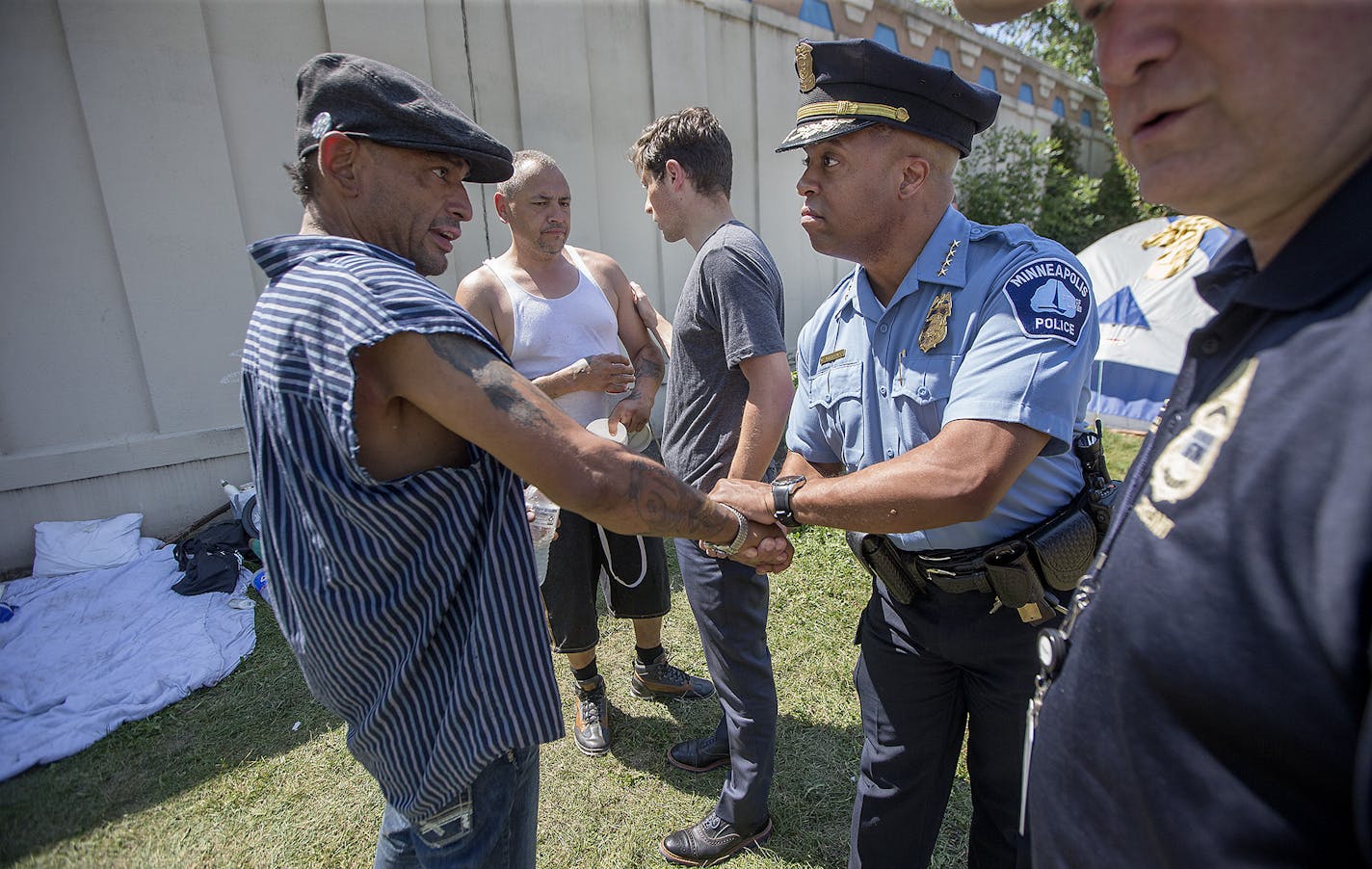 Minneapolis Police Chief Medaria Arradondo, center, Minneapolis Mayor Jacob Frey, left, and Minneapolis Police Sgt. Grant Snyder, right, visited a homeless encampment near 16th Avenue South & East Franklin Avenue Wednesday, August 8, 2018 in Minneapolis, MN. ] ELIZABETH FLORES &#xef; liz.flores@startribune.com