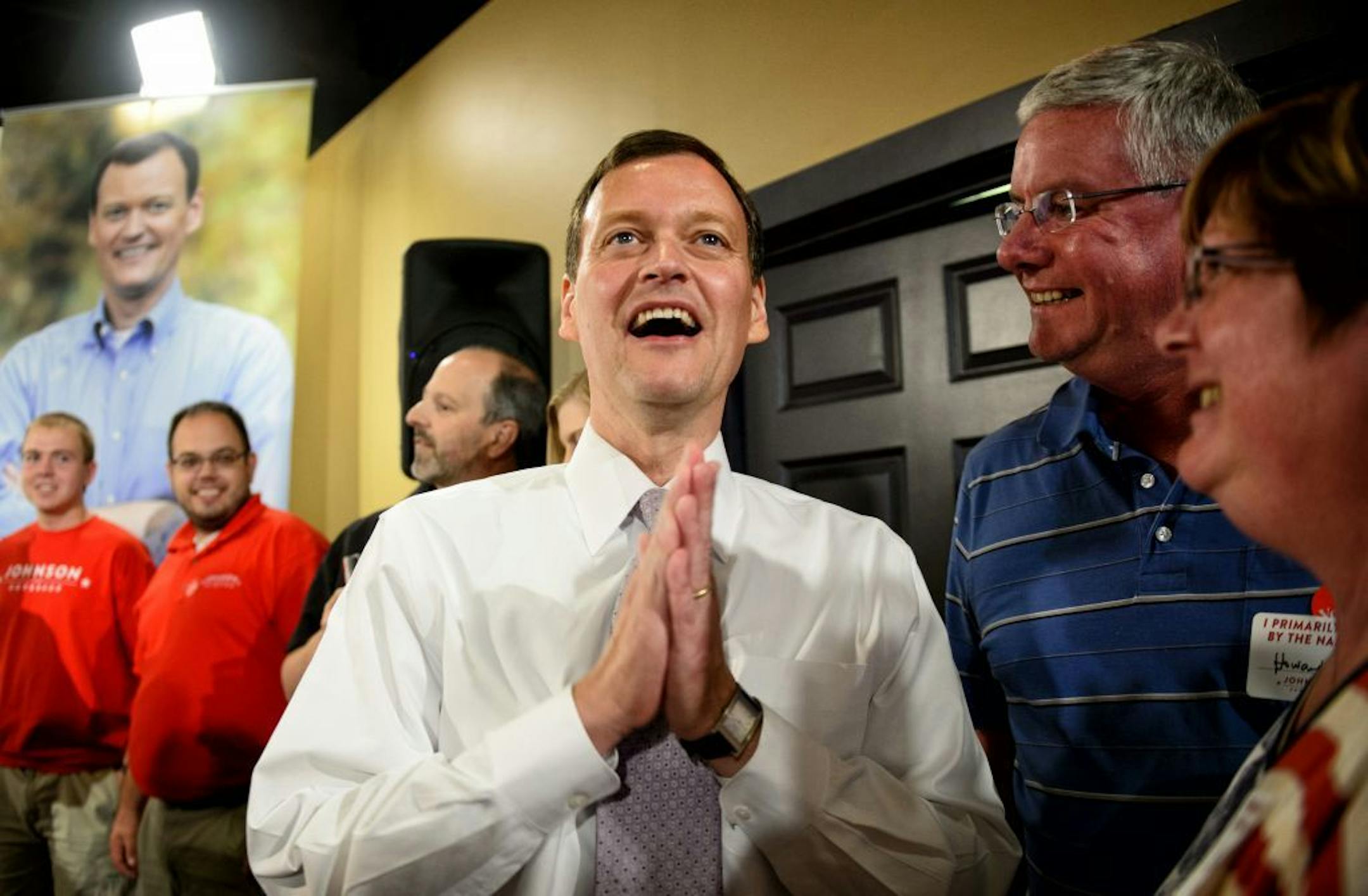 Jeff Johnson smiles as he looks at election results on a television screen showing him ahead in the race for the Republican nomination for Minnesota governor, in Plymouth, Minn., Tuesday night, Aug. 12, 2014.
