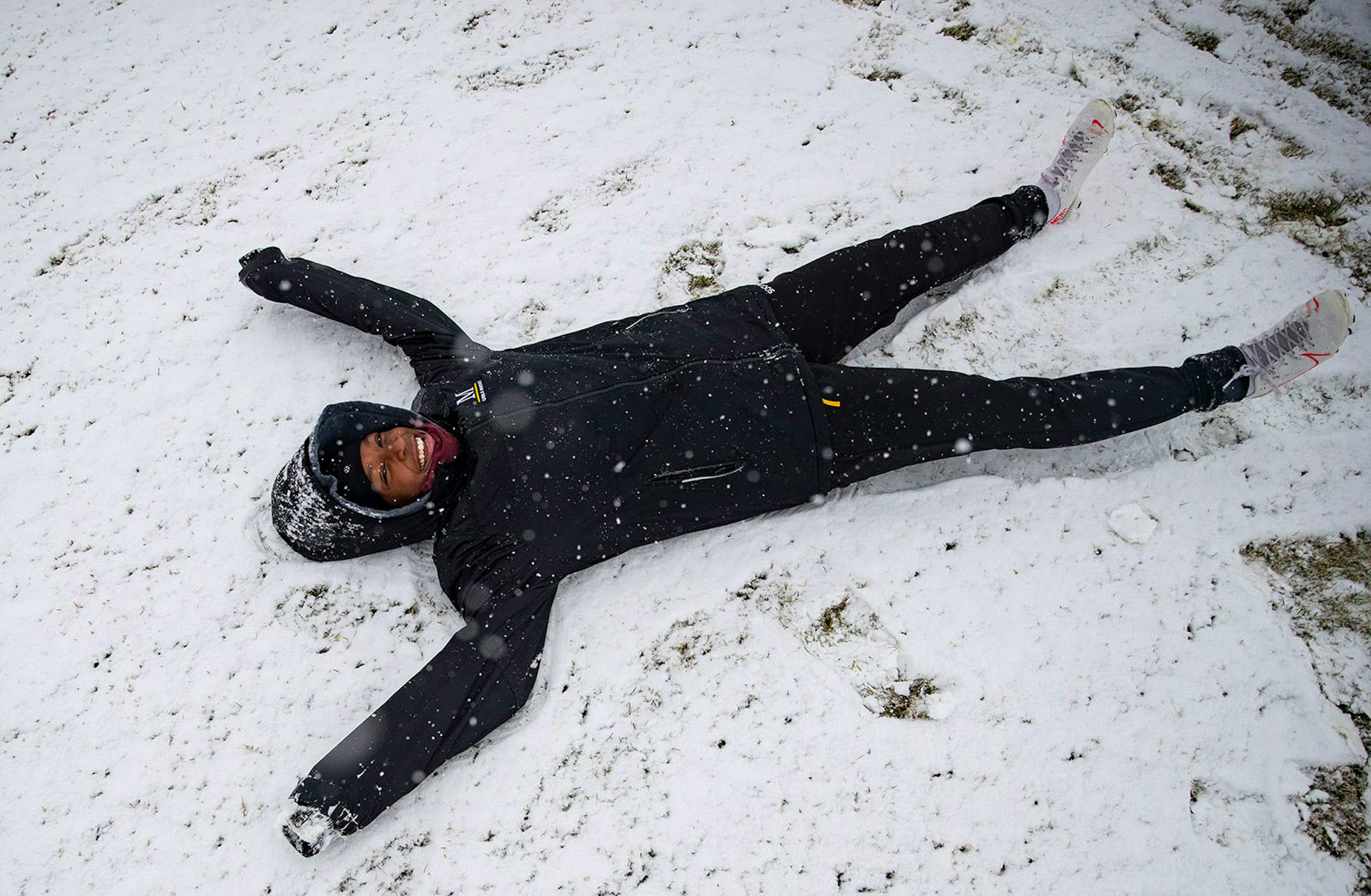 Nina Thorson, a player on the Marshall School girl's soccer team, did snow angels during a snow-filled practice on Tuesday afternoon in Duluth.