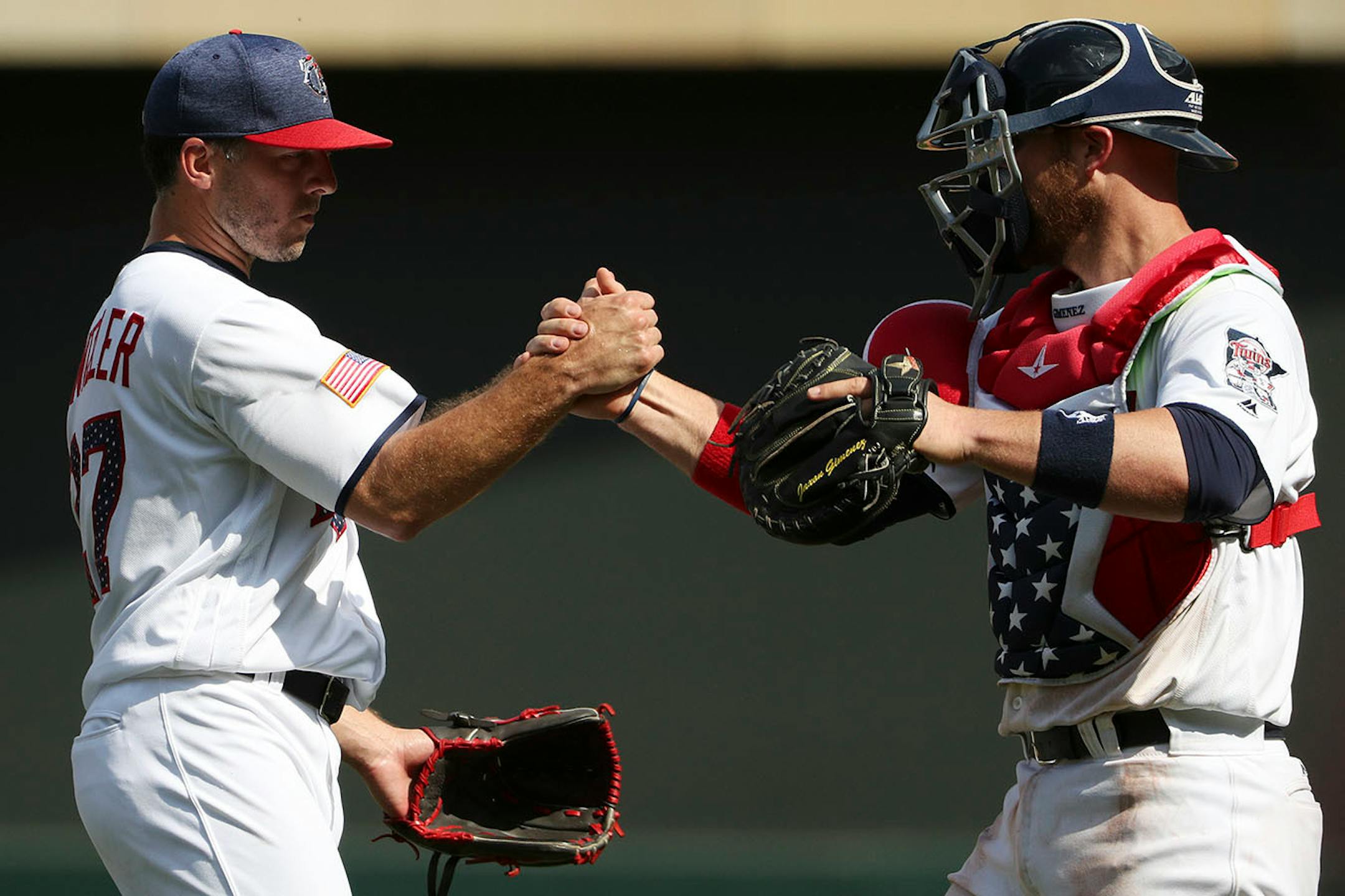 Minnesota Twins relief pitcher Brandon Kintzler (27) celebrated the win with Minnesota Twins catcher Chris Gimenez (38) after Tuesday's victory.