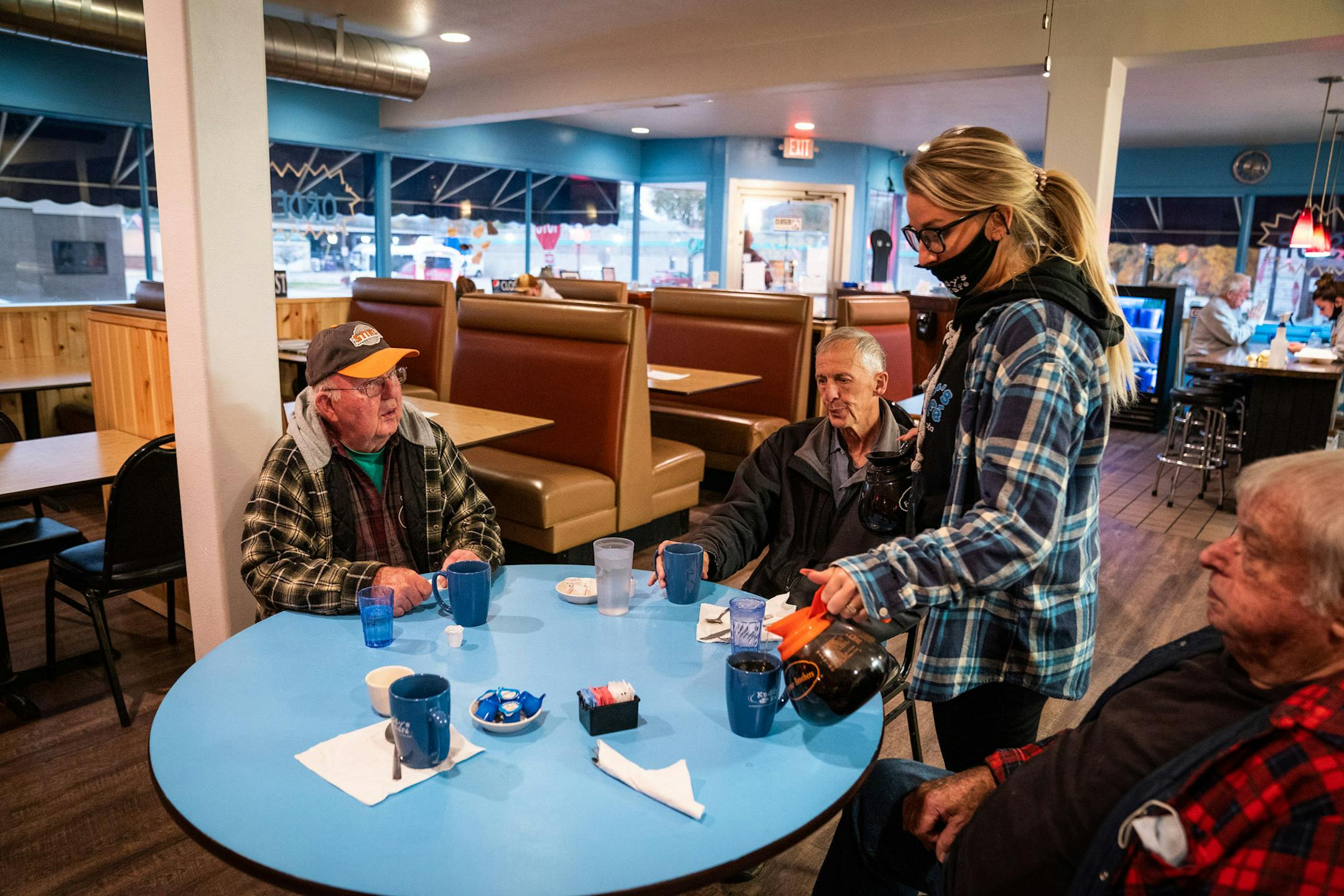 Waitress Jena Juarez served coffee to morning regulars Jerry Abnet, from left, Raymond Nesbit and Charlie Lind at Kaddy's Kafe in La Crescent. The first COVID-19 related death in Houston County was Abnet's son-in-law's mother in the town of Houston.