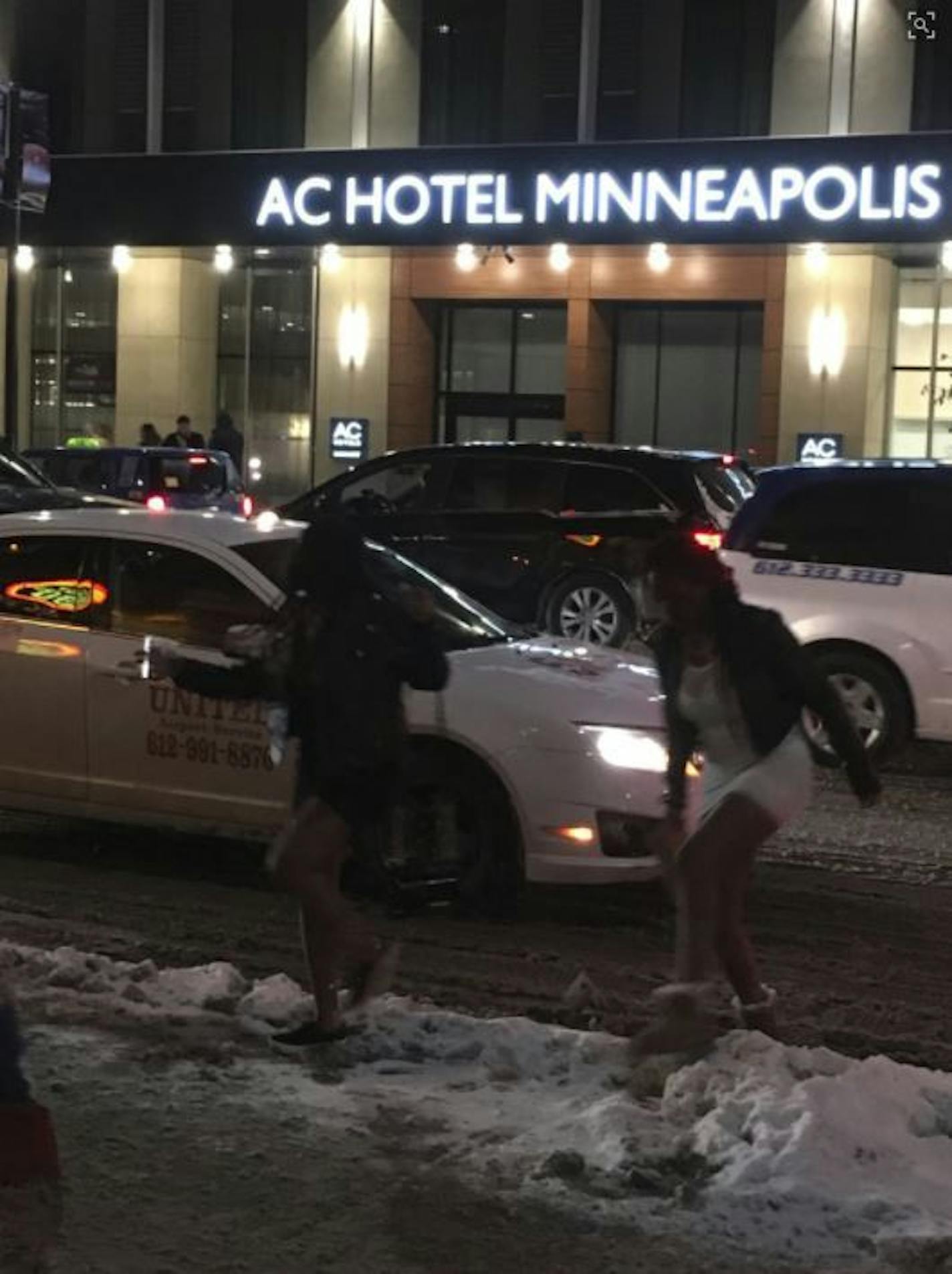 Downtown revelers sprint from their cab to a downtown Minneapolis bar as the city filled with revelers on the eve of the Super Bowl.