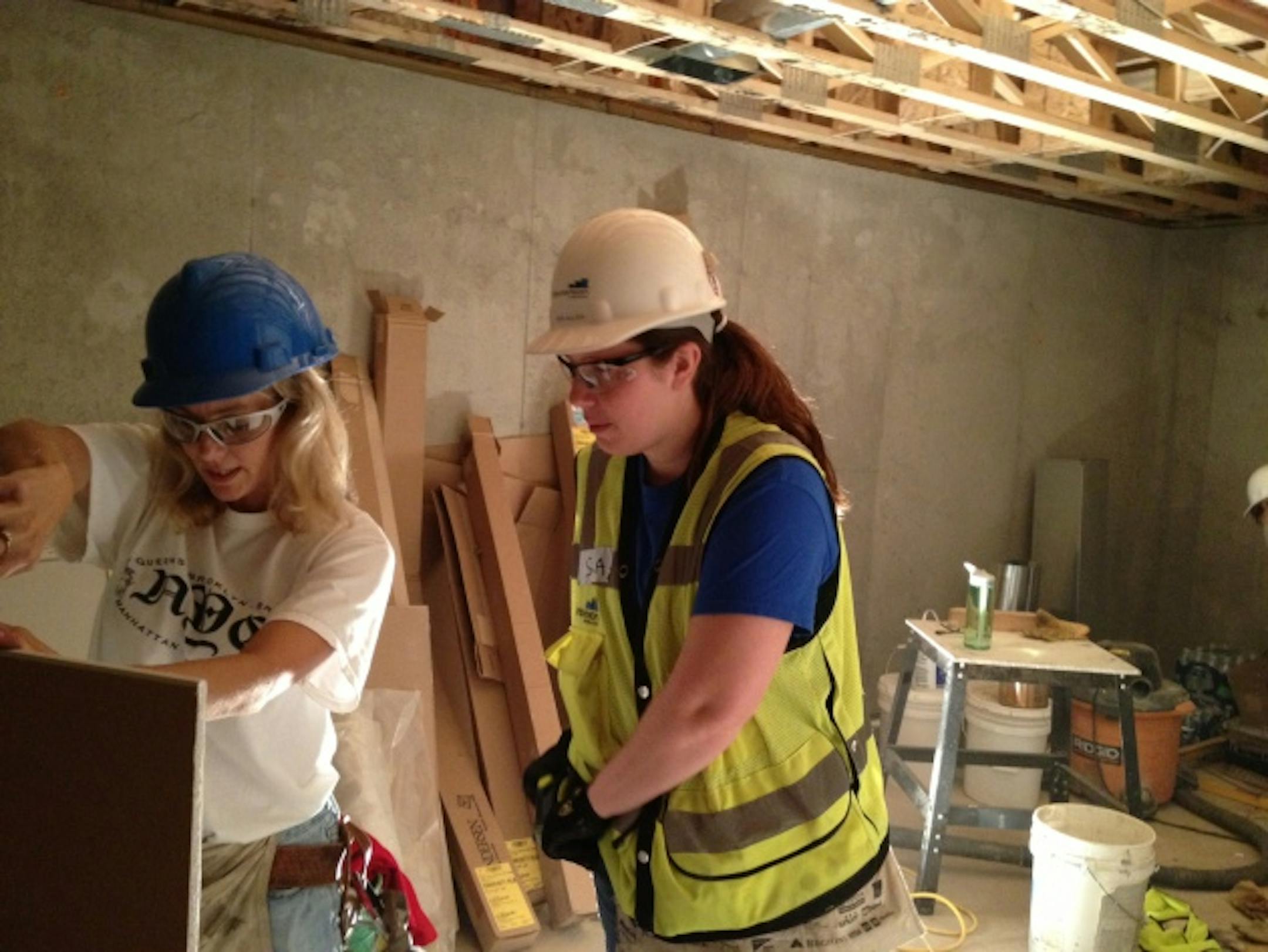Kelly Thommes, left, and Sara Aulizia, work on the North Minneapolis home.
