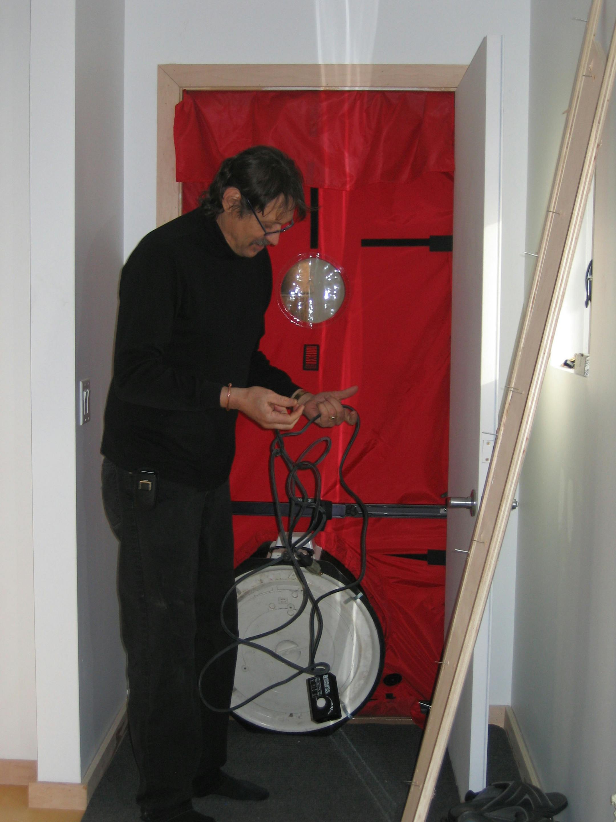 Jimmie Sparks of the Neighborhood Energy Connection set up a blower test through the garage door entry of the Hammonds' new house.