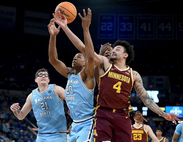 Indiana State's Jayson Kent (20) and the Gophers' Braeden Carrington (4) reach for a rebound during the second round of the NIT on Sunday in Terre Hau