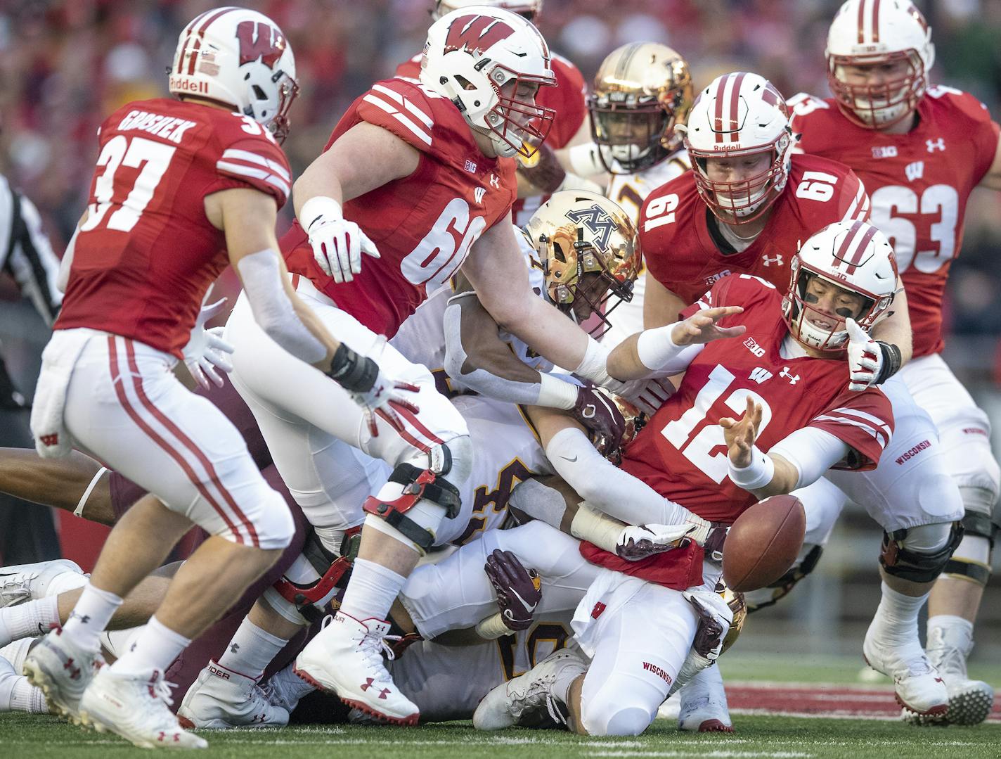 Wisconsin's quarterback Alex Hornibrook loses the ball during the first quarter at Camp Randall Stadium, Saturday, November 24, 2018 in Madison, Wis. It's the 128th meeting between the two teams. ] ELIZABETH FLORES &#x2022; liz.flores@startribune.com