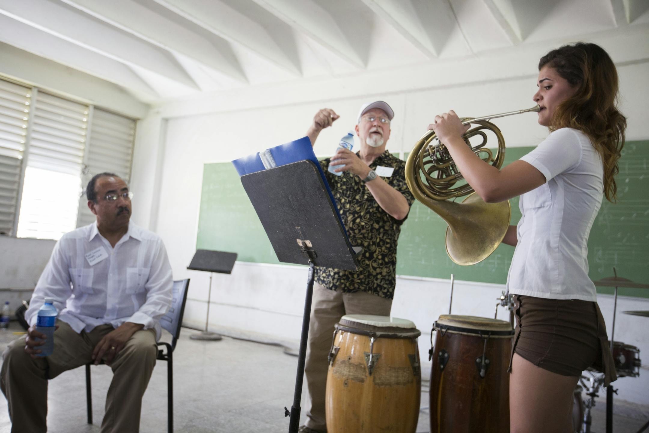 Horn player Liyani Marrero Hernandez plays for Minnesota Orchestra horn player Herbert Winslow, center, and trumpet player Manny Laureano at the Escuela Nacional de Musica in Havana, Cuba on Thursday, May 14, 2015.