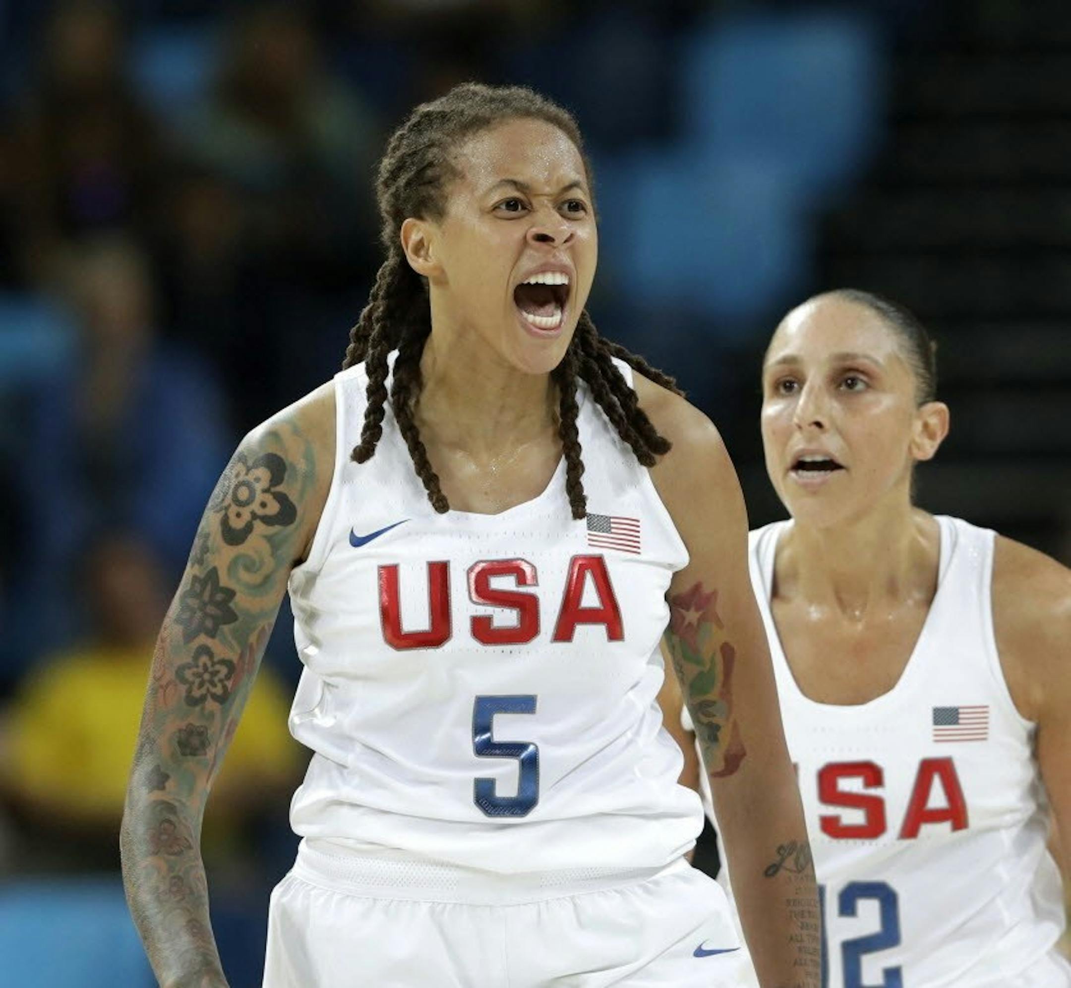 United States' Seimone Augustus (5), with teammate Diana Taurasi, reacts to a score against Japan during a women's quarterfinal round basketball game at the 2016 Summer Olympics in Rio de Janeiro, Brazil, Tuesday, Aug. 16, 2016. (AP Photo/Eric Gay)